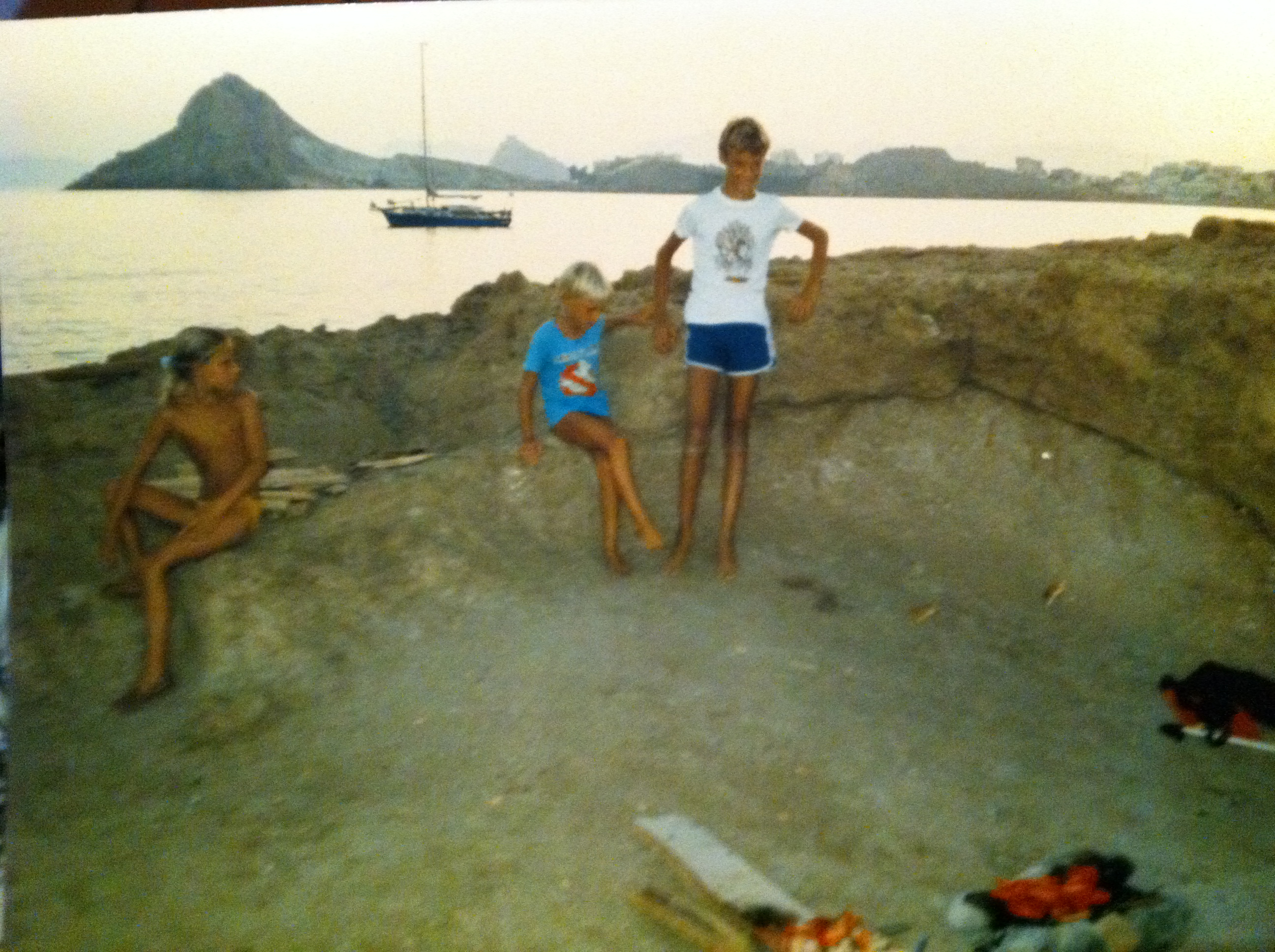Three of us on a rocky shore at sunset.